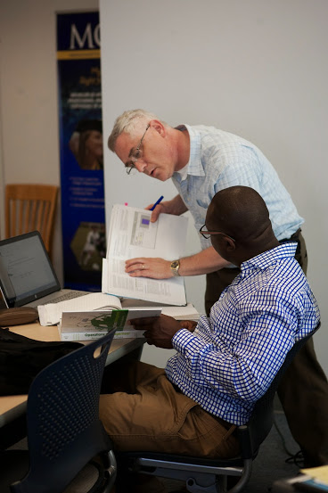 Professor assisting adult learner