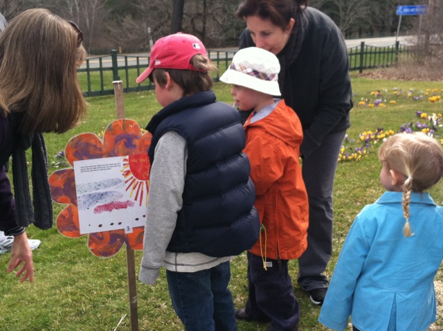 Children reading a hand painted sign