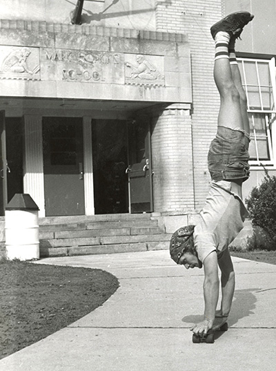 Skater doing a handstand on a skateboard