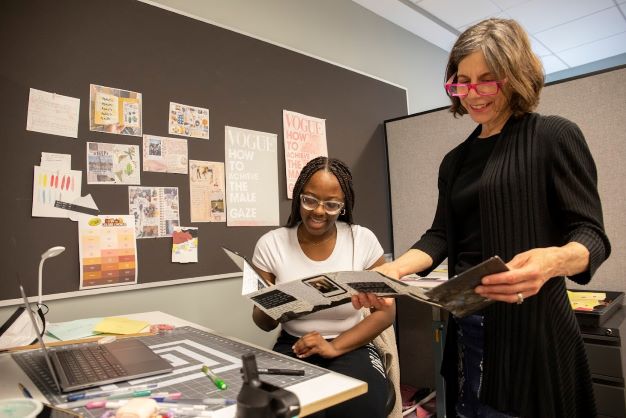 Professor review a brochure with a student